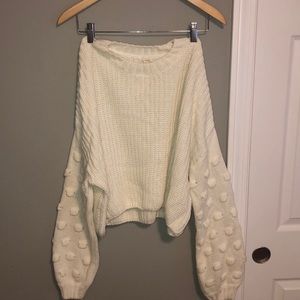 White sweater with pom pom sleeve